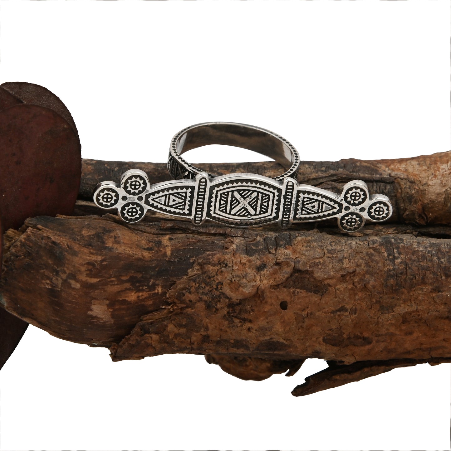 Tuareg Engraved Ring with double silver plating displayed on a white background resting on a tree branch with oxidized finish