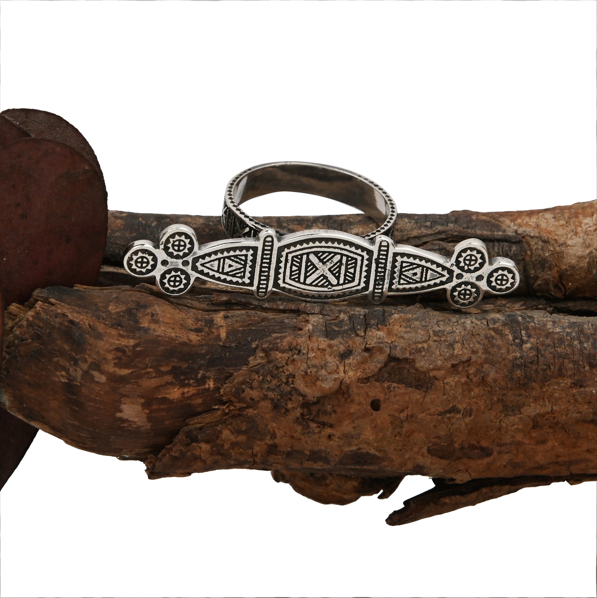 Tuareg Engraved Ring with double silver plating displayed on a white background resting on a tree branch with oxidized finish